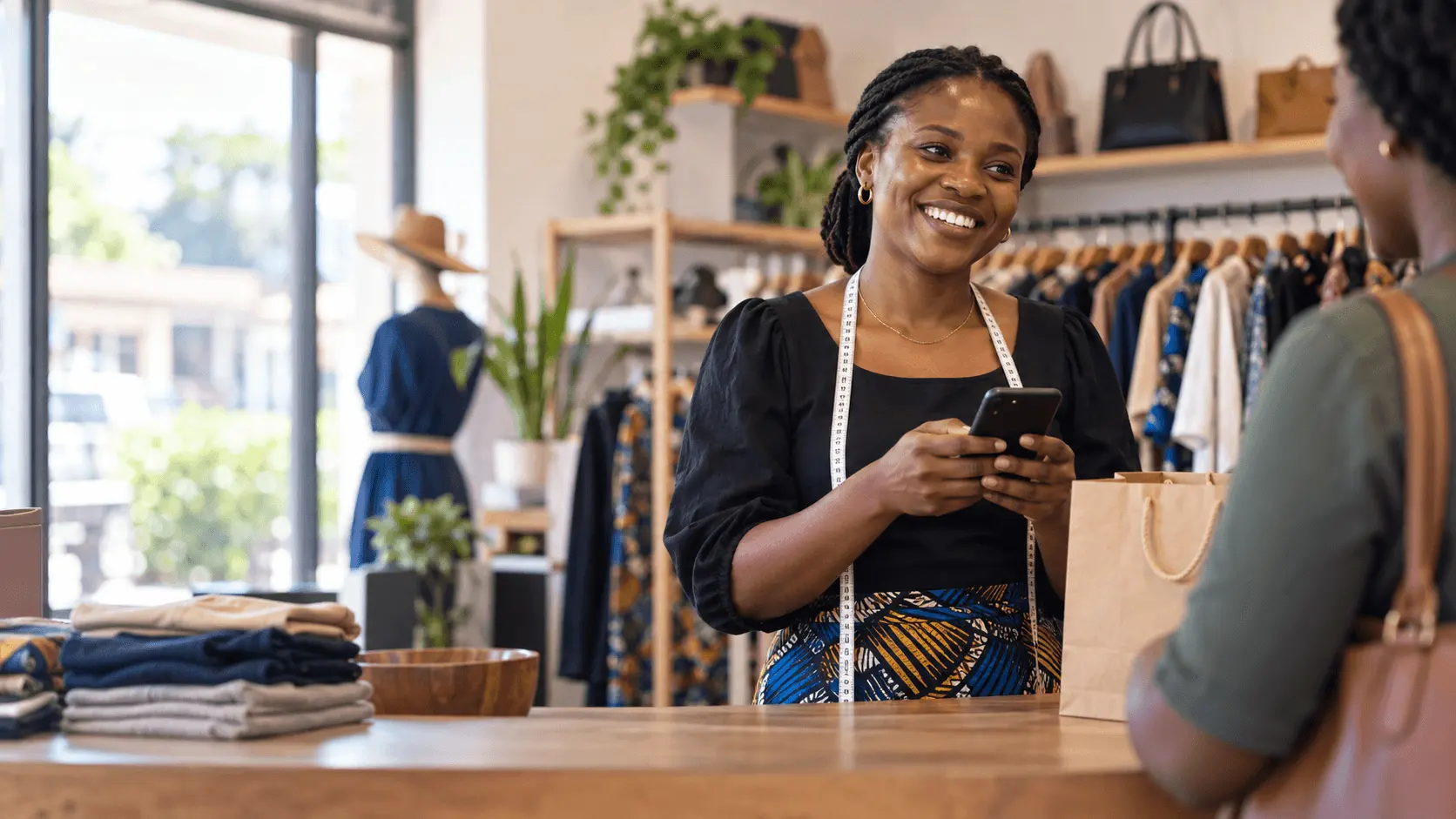 A customer paying at a boutique counter